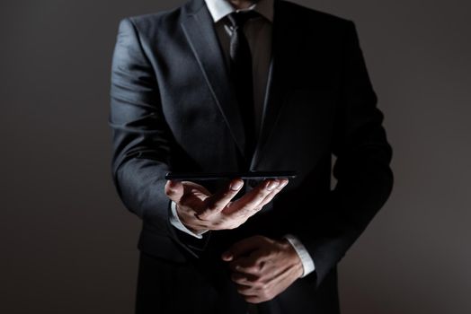 Businessman Holding Tablet With Both Hands And Presenting Important Data