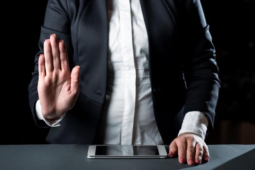 Businesswoman Having Tablet On Desk And Pointing Important Ideas With Hand.