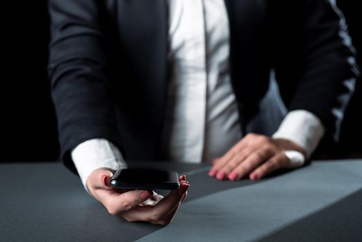 Businesswoman Holding Cellphone And Presenting Important Informations.