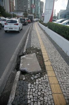 salvador, bahia, brazil - july 19, 2022: Pedestrian sidewalk with damaged floor on a street in Salvador city.