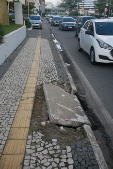 salvador, bahia, brazil - july 19, 2022: Pedestrian sidewalk with damaged floor on a street in Salvador city.