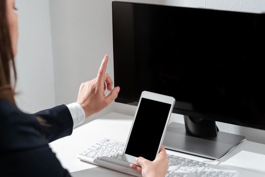 Woman Holding Mobile Phone And Pointing With One Finger On Important News.