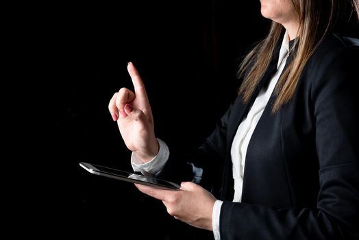 Businesswoman Holding Tablet And Pointing With One Finger On Important News