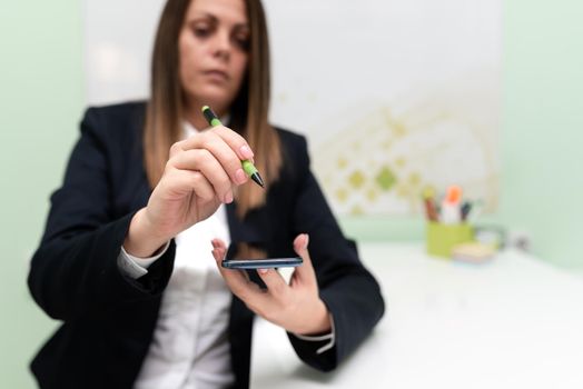 Woman Holding Tablet And Pointing Important Informations With Pen In Hand.