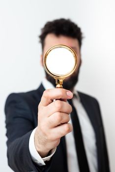 Man Having Magnifying Glass To Point Important Informations.