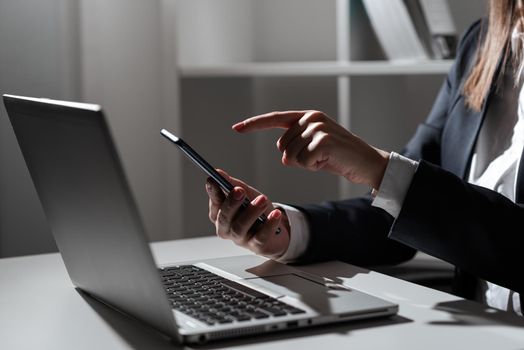 Woman Holding Tablet In One Hand And Pointing On News With One Finger.