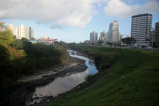 salvador, bahia, brazil - july 19, 2022: view of a sewage water channel on the Camurujipe river in the city of Salvador.