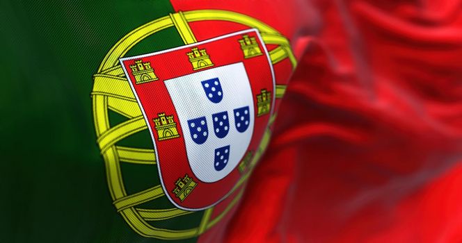 Close-up view of Portugal national flag waving in the wind. Portugal is an European country located in western Europe. Fabric background