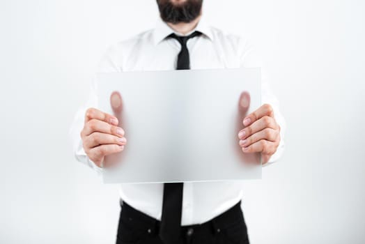 Businessman With Placard Presenting Important Strategies For Progress.