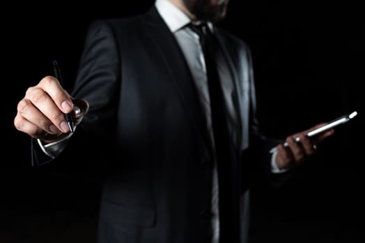 Businessman Holding Phone And Pointing Important Message With Pen.