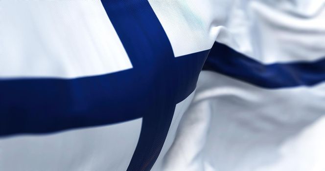 Close-up view of Finland national flag waving in the wind. Finland is a Scandinavian country located in northern Europe. Fabric background