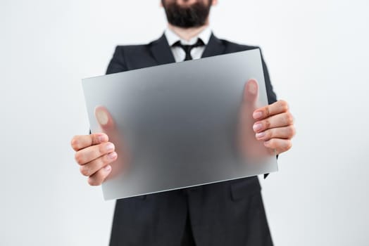 Man Holding Blank Placard And Representing Business Advertisement.