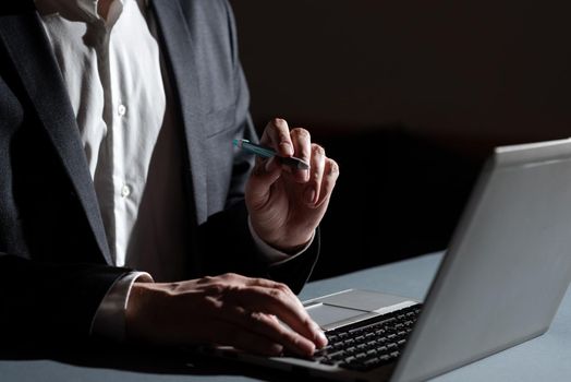 Man Typing Important Data Into Laptop And Pointing New Idea With Pen.