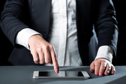 Businesswoman Having Tablet On Desk And Pointing On It With One Finger.