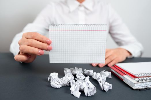 Businesswoman Holding Note With Important Message On Office Desk.