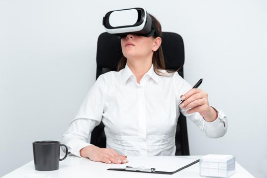 Woman Wearing Goggles And Learning Skill With Virtual Reality Simulator.