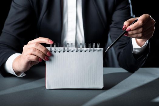 Businesswoman Holding Note With Important Message And Pointing With Pen.