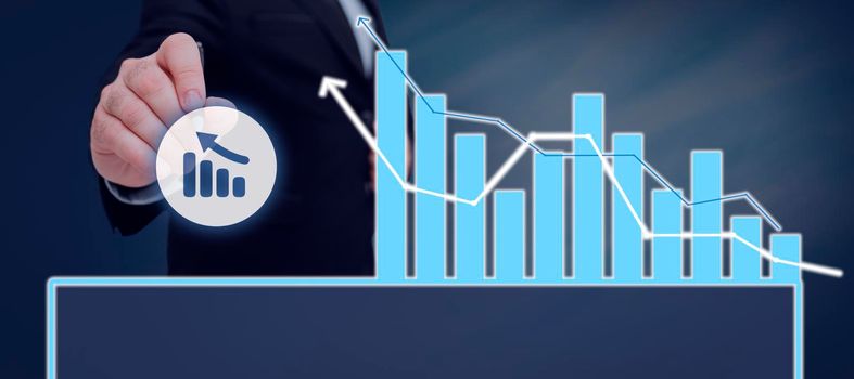 Man With Pen Pointing On A Chart Showing Crucial Diagrams And Data.