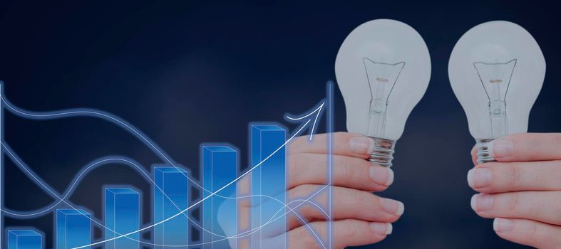 Woman Holding Light Bulbs By Digital Graphs Presenting New Ideas.