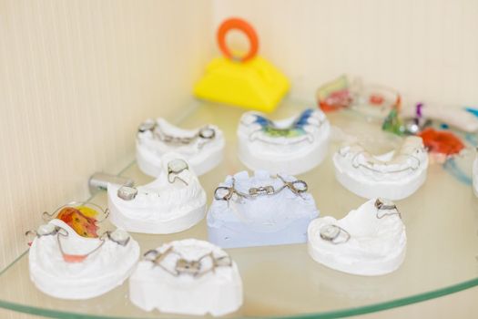 Children colored orthodontic plate with a screw, modern made of colored plastic