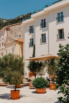 Historic city of Perast at Bay of Kotor in summer, Montenegro. Scenic panorama view of the historic town of Perast at famous Bay of Kotor with blooming flowers on a beautiful sunny day with blue sky and clouds in summer, Montenegro, southern Europe