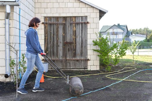 Woman working the land of a vegetable home garden in the traditional way