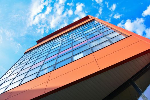 Modern orange building with offices and glass windows