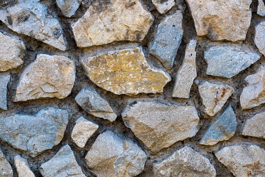 Texture, background for further work. A wall of coarse stone with a wide gap