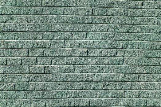 Texture, background for further work. Wall of gray-green brick segments rustic
