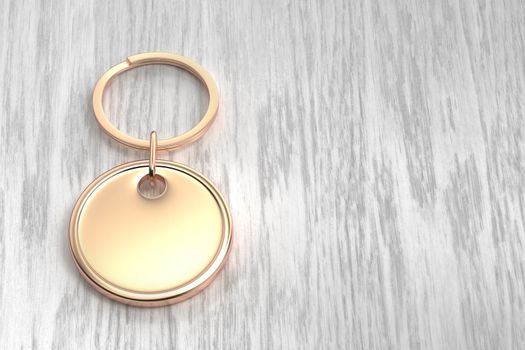 Rose gold round keychain on the wooden table
