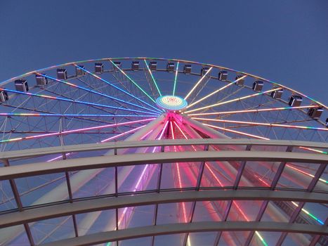 Downtown Seattle, Washington, USA - June 25, 2016 - Looking up at Ferris Wheel with LED lights on in the background.