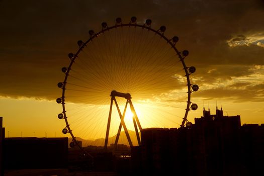 LAS VEGAS - JUNE 29, 2015 - The High Roller Wheel light up at as sunrise comes through the wheel at dawn at the center of the Las Vegas Strip on June 29, 2015 in Las Vegas. The High Roller is the world's largest observation wheel.
