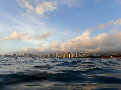 Dramatic Dusk reflects on the water on ocean of Waikiki on Oahu, Hawaii.