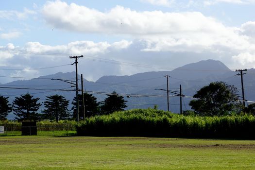 Kahi Kani Park with powerlines, birds in the air and mountains in the distance on Oahu, Hawaii 