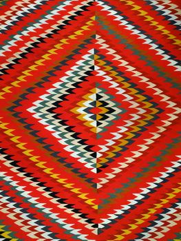 Pattern Red, Orange, White, Green, Black, and blue Diamond Blanket/ Rug - Navajo Artist, made about 1885 of cotton and wool.                              