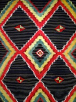 Pattern Red, Orange, White, Green, Black, yellow and blue Diamond Blanket/ Rug - Navajo Artist, made about 1885 of cotton and wool.                              