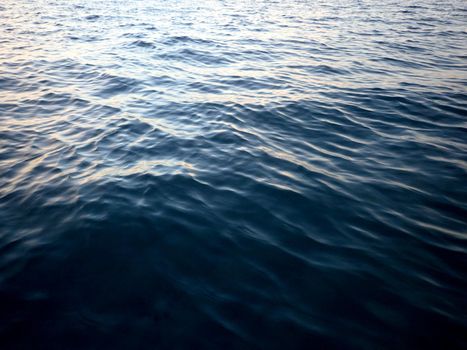 Shades of Turquoise Blue Ocean Water ripples off the coast of Oahu reflecting light at duskl.  Good for backgrounds textures.