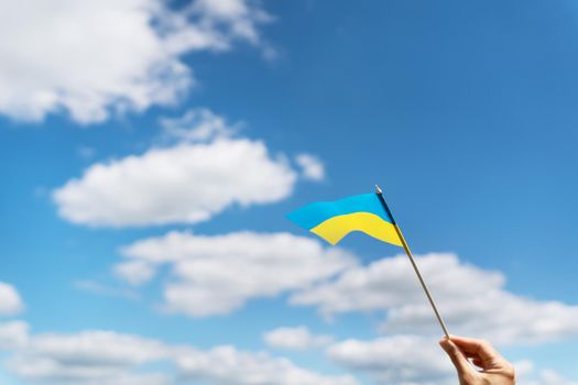 Pray for Ukraine. Ukrainian national yellow-blue flag against a beautiful sky. Independence Day 24 August