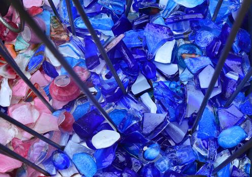 Broken violet and pink glass Background or texture