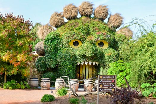 TERRA BOTANICA, ANGERS, FRANCE - SEPTEMBER 24, 2017: Head of a monster covered with ivy in a park landscape design. Grass figure