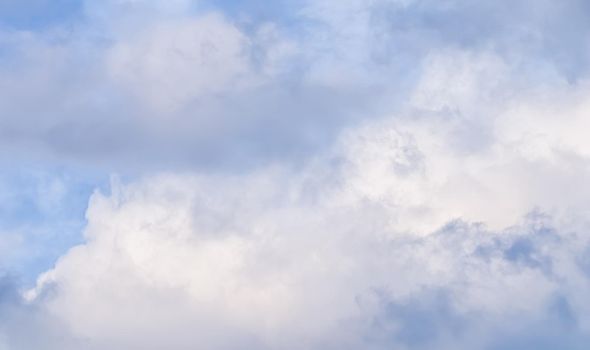 Background of cloudy sky with pale pink clouds at sunset