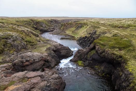 Fantastic landscape with flowing rivers and streams with rocks and grass in Iceland 