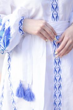 close up of national traditional ukrainian clothes. details of woman in embroidered dress. unrecognizable person.