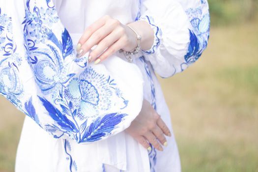 close up of national traditional ukrainian clothes. details of woman in embroidered dress. unrecognizable person.