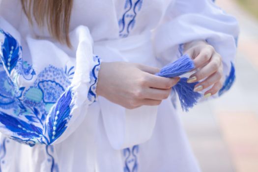 close up of national traditional ukrainian clothes. details of woman in embroidered dress. unrecognizable person.