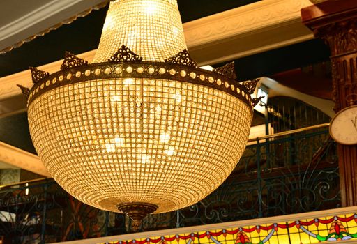 Large crystal chandelier on a black background.