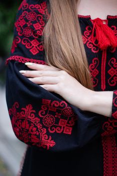 close up of national traditional ukrainian clothes. details of woman in embroidered dress. unrecognizable person.