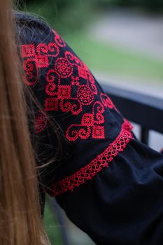 close up of national traditional ukrainian clothes. details of woman in embroidered dress. unrecognizable person.