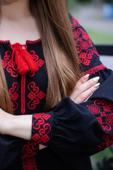 close up of national traditional ukrainian clothes. details of woman in embroidered dress. unrecognizable person.