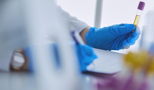 Woman researcher is surrounded by medical vials and flasks, isolated on white background.